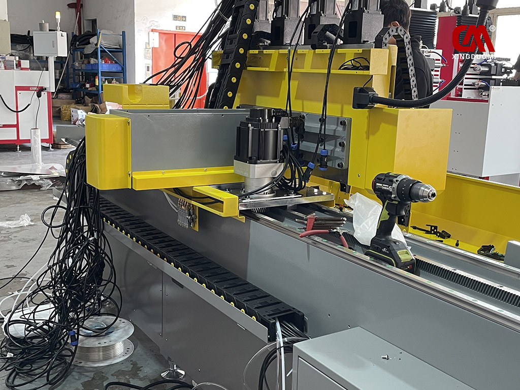 DUOMI CNC engineers are installing the electrical wiring and control components on the thermal drilling and tapping machine.jpg