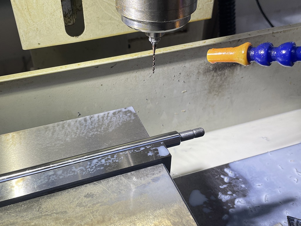 CNC drilling machine drilling micro holes on stainless steel shafts